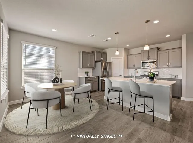 a view of kitchen with dining table and chairs