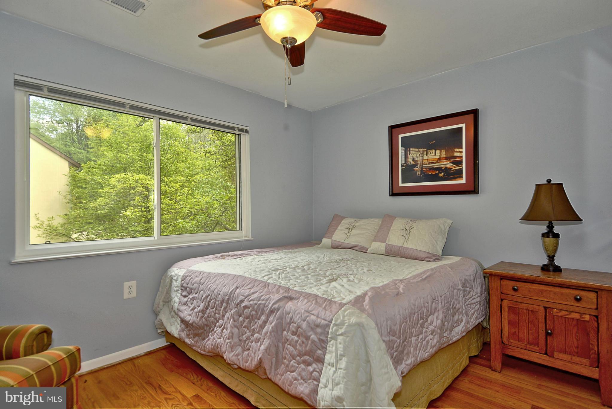 1601 Inlet Court Reston, VA 20190 - Photo 14 of 29 a bedroom with a bed and a chandelier