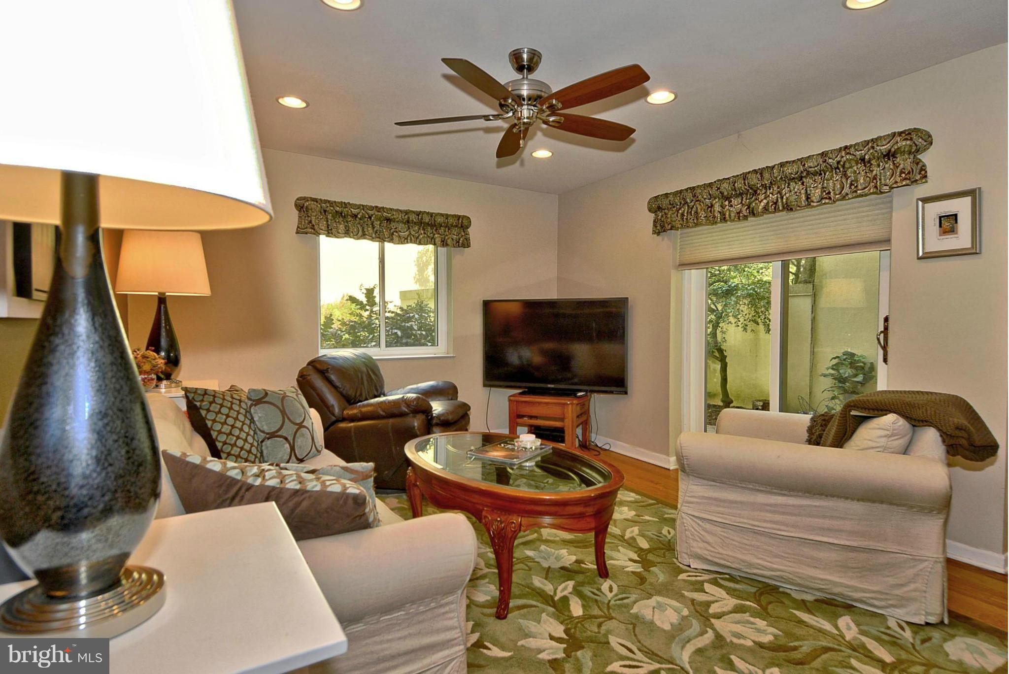 1601 Inlet Court Reston, VA 20190 - Photo 7 of 29 a living room with furniture a flat screen tv and a large window