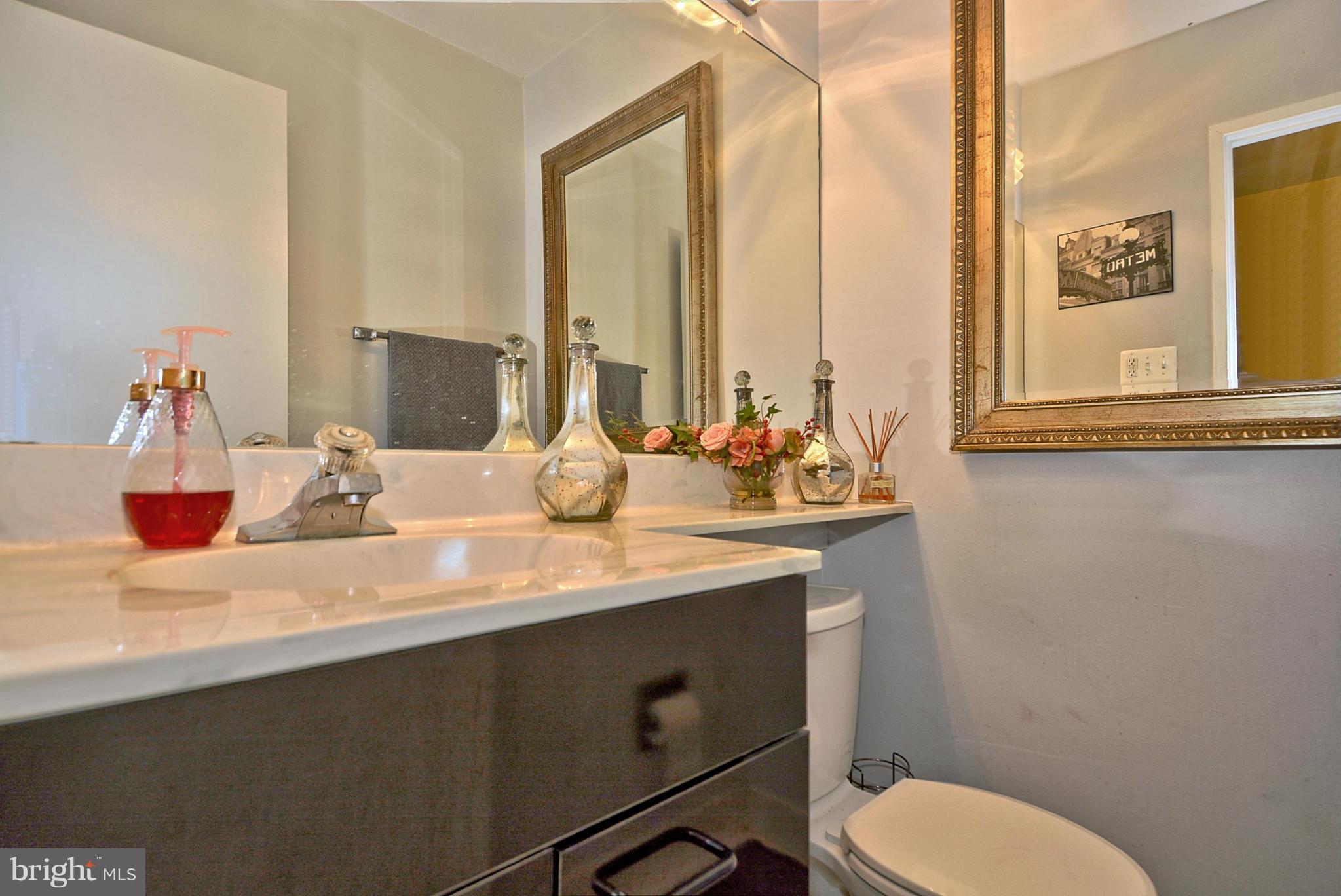 1601 Inlet Court Reston, VA 20190 - Photo 8 of 29 a bathroom with a sink a toilet and a mirror