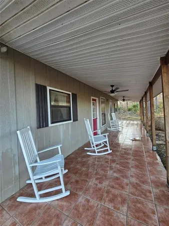 a building outdoor space with patio furniture and windows