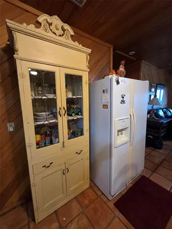 a white refrigerator freezer and a stove sitting inside of a kitchen