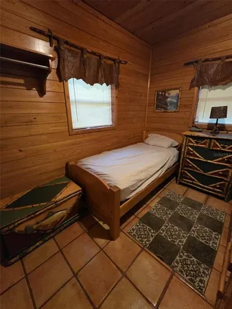 a room with pool table and windows