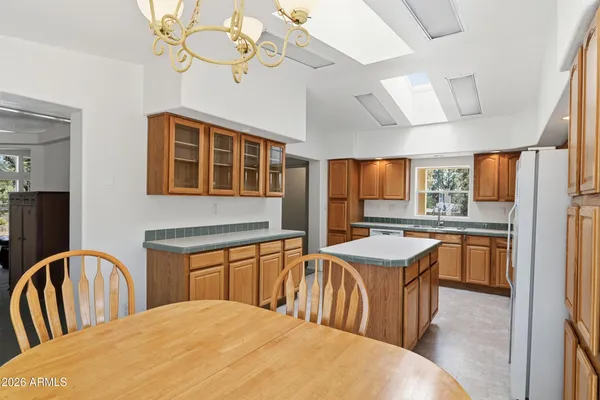 a kitchen with stainless steel appliances granite countertop a sink a stove and a refrigerator