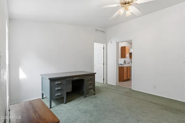 an empty room with closet and windows