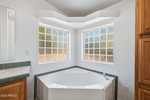 a white bath tub sitting next to a window