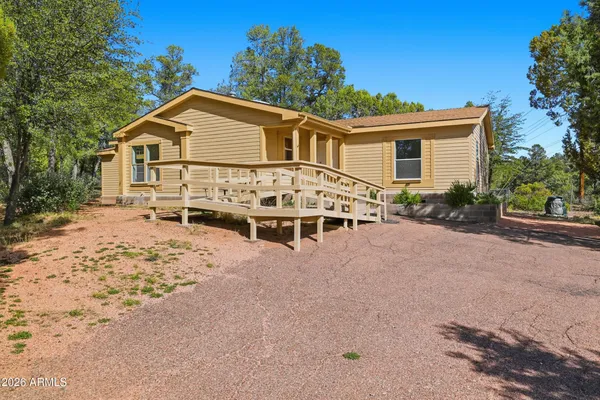 a view of a house with wooden fence