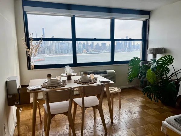 a dining room with furniture and window