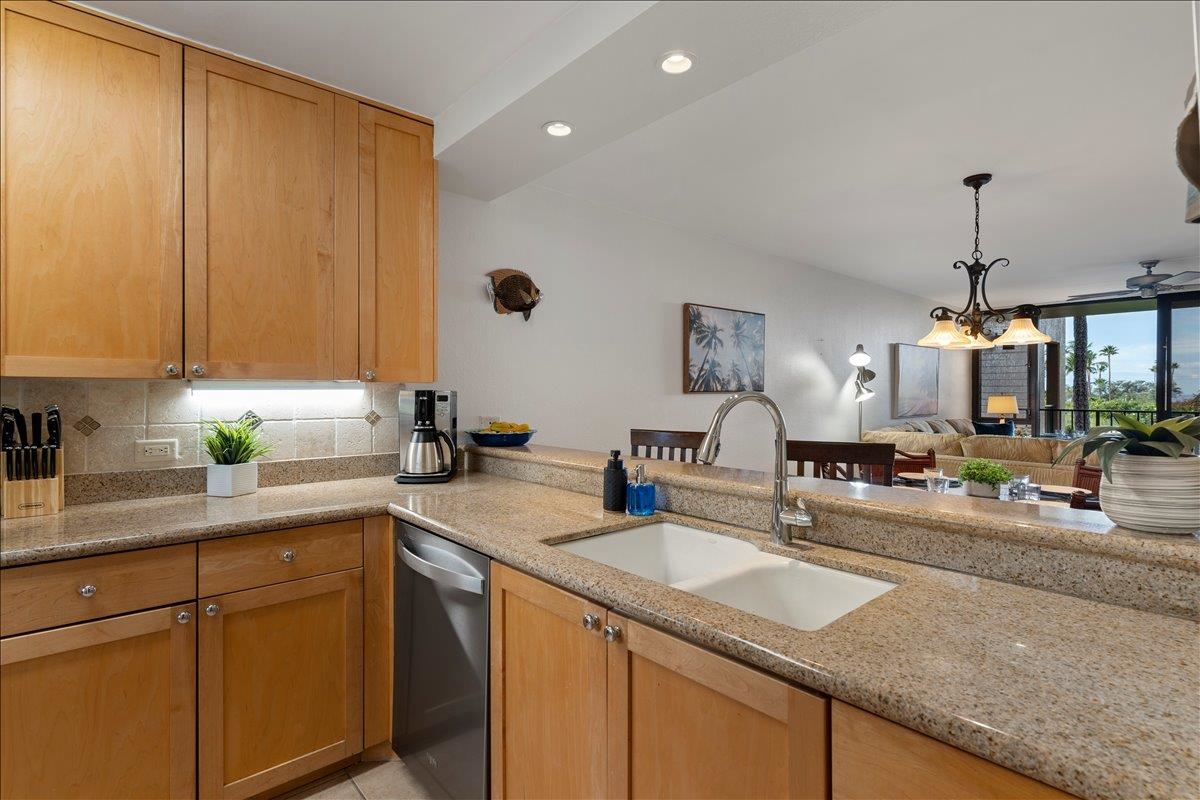 2695 South Kihei Road, Unit 5205 Kihei, HI 96753 - Photo 14 of 43 a kitchen with stainless steel appliances granite countertop sink stove and cabinets