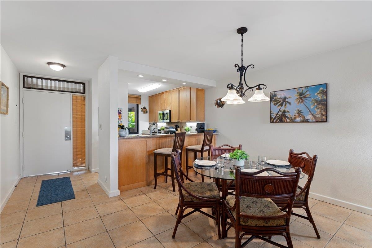 2695 South Kihei Road, Unit 5205 Kihei, HI 96753 - Photo 17 of 43 a view of a dining room with furniture and chandelier