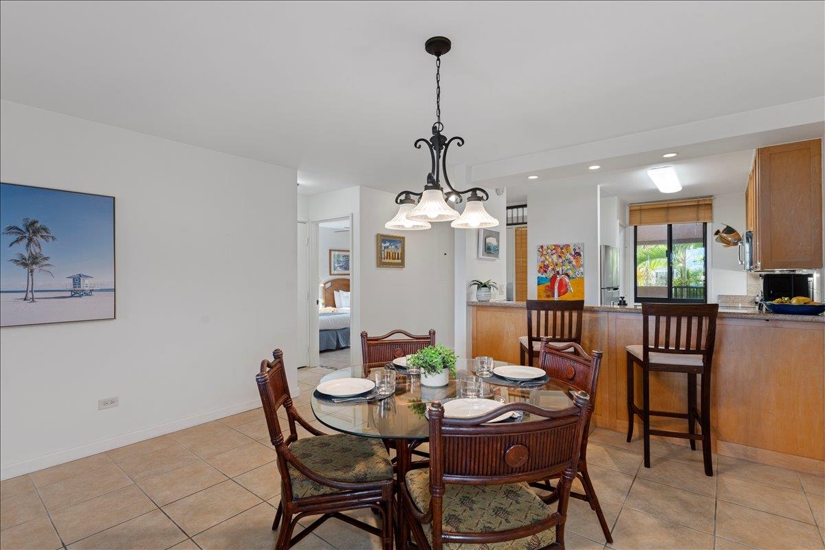 2695 South Kihei Road, Unit 5205 Kihei, HI 96753 - Photo 18 of 43 a view of a dining room with furniture a chandelier and a window