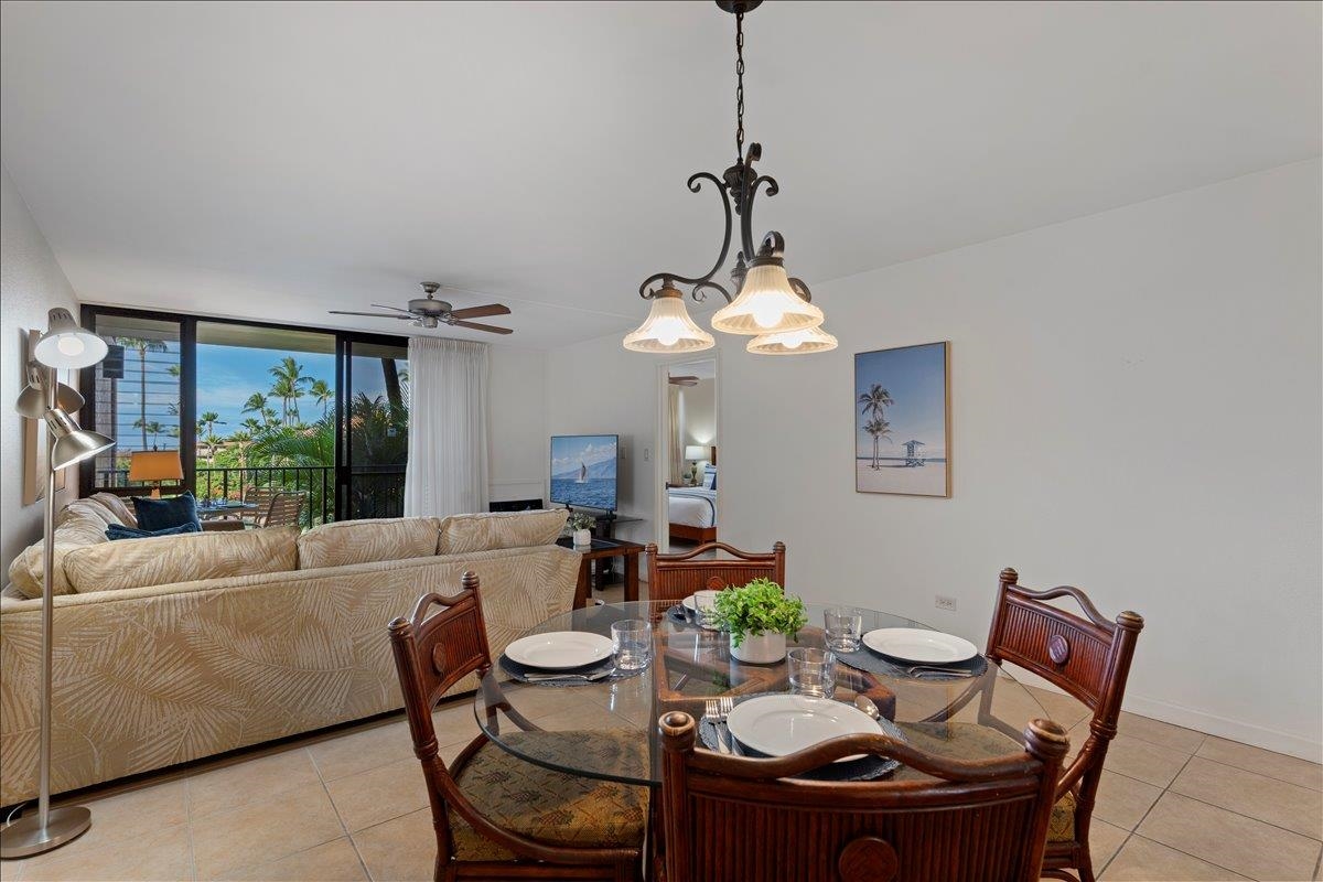 2695 South Kihei Road, Unit 5205 Kihei, HI 96753 - Photo 19 of 43 a view of a dining room with furniture a chandelier and wooden floor