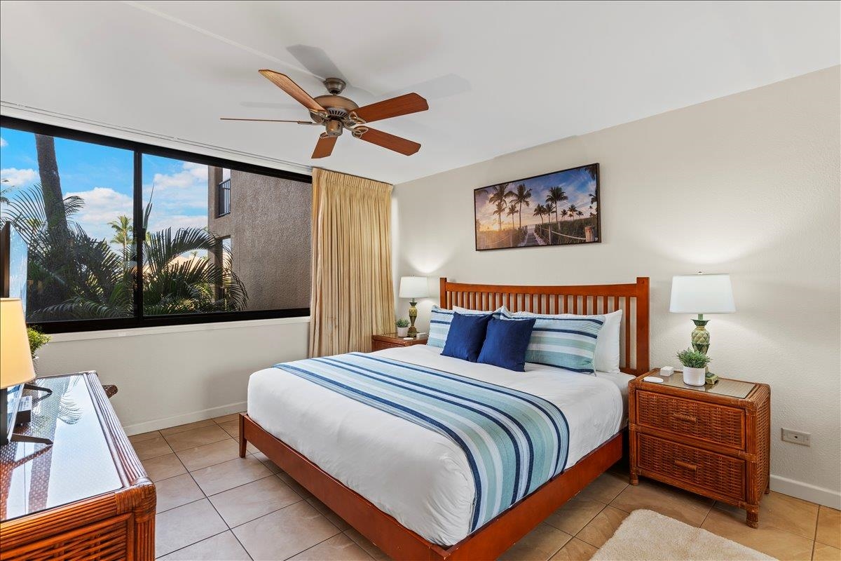 2695 South Kihei Road, Unit 5205 Kihei, HI 96753 - Photo 27 of 43 a bedroom with a bed and a painting on the wall