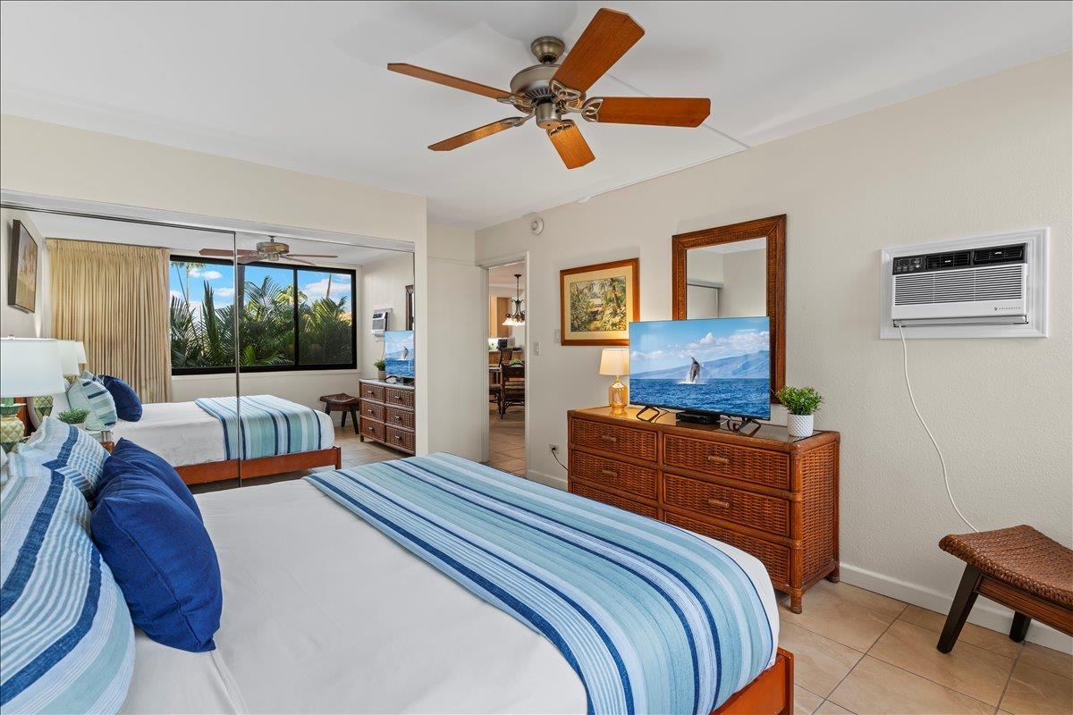2695 South Kihei Road, Unit 5205 Kihei, HI 96753 - Photo 30 of 43 a bedroom with a bed and a chandelier