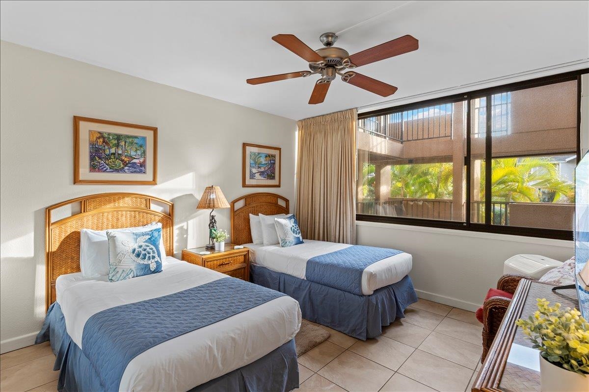 2695 South Kihei Road, Unit 5205 Kihei, HI 96753 - Photo 32 of 43 a bedroom with two beds and a large window