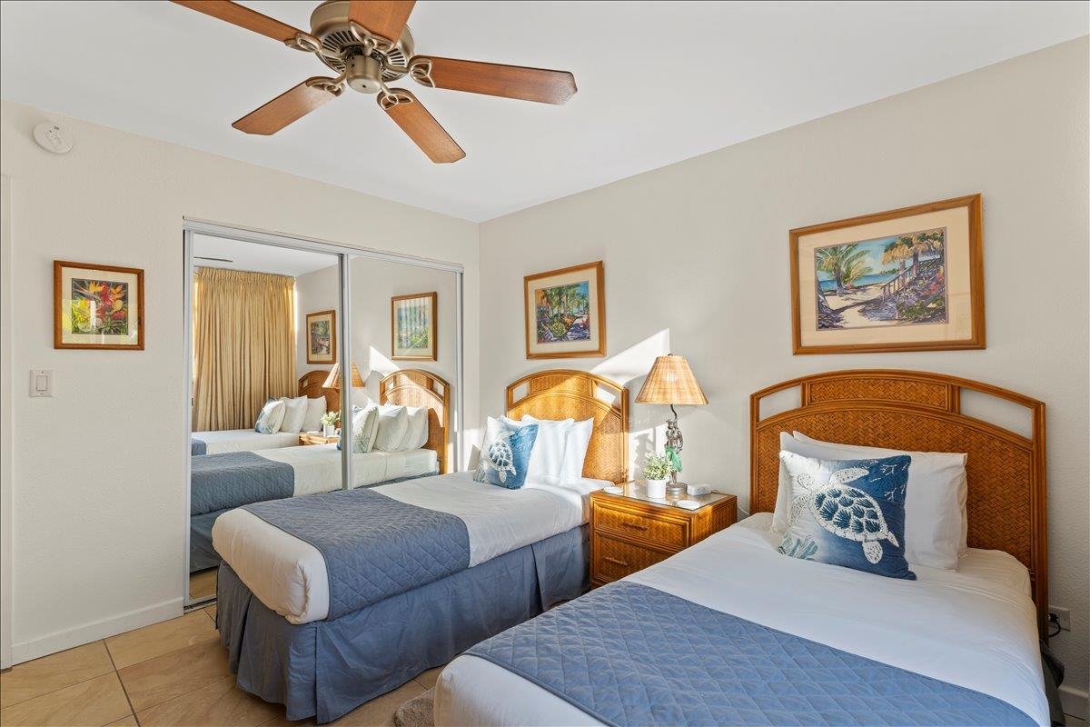 2695 South Kihei Road, Unit 5205 Kihei, HI 96753 - Photo 34 of 43 a bedroom with furniture and a chandelier