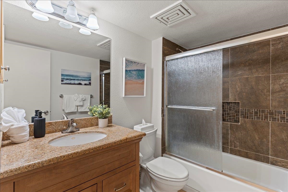 2695 South Kihei Road, Unit 5205 Kihei, HI 96753 - Photo 36 of 43 a bathroom with a granite countertop sink toilet and shower