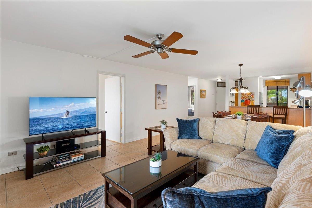 2695 South Kihei Road, Unit 5205 Kihei, HI 96753 - Photo 6 of 43 a living room with furniture a flat screen tv and a dining table