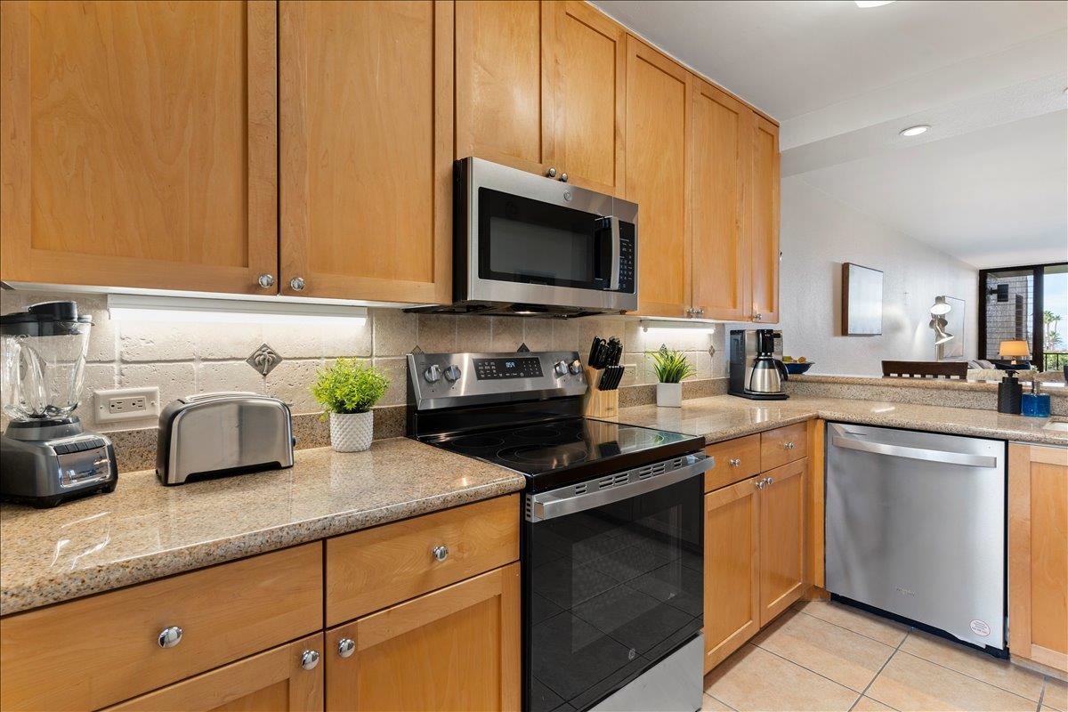 2695 South Kihei Road, Unit 5205 Kihei, HI 96753 - Photo 7 of 43 a kitchen with granite countertop a sink stainless steel appliances and cabinets