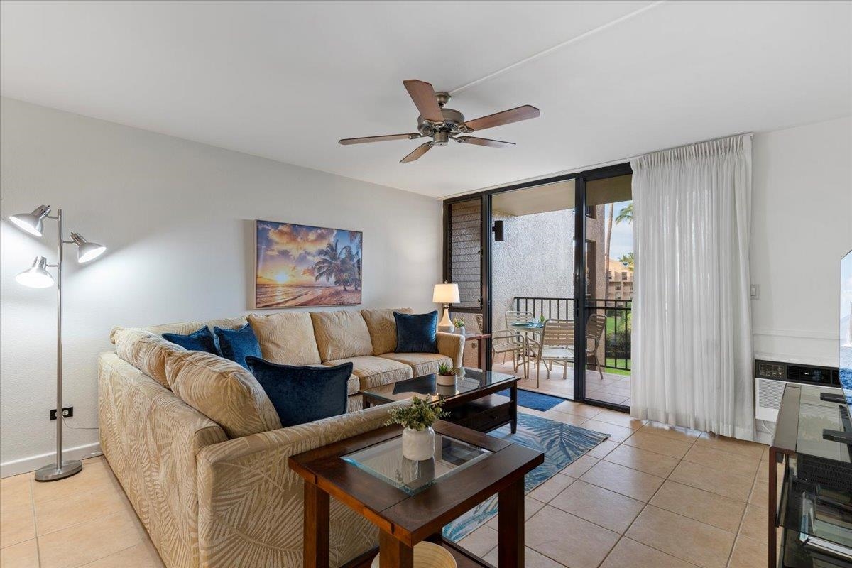 2695 South Kihei Road, Unit 5205 Kihei, HI 96753 - Photo 9 of 43 a living room with furniture a large window and a chandelier