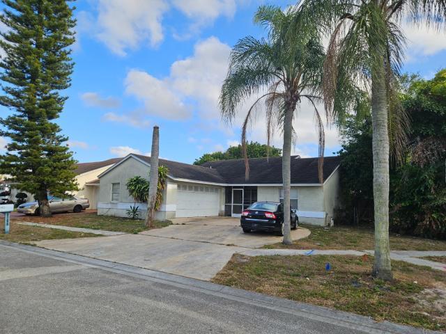5454 River Plantation Road Lake Worth, FL 33463 - Photo 2 of 3 a car parked in front of a house on a sidewalk