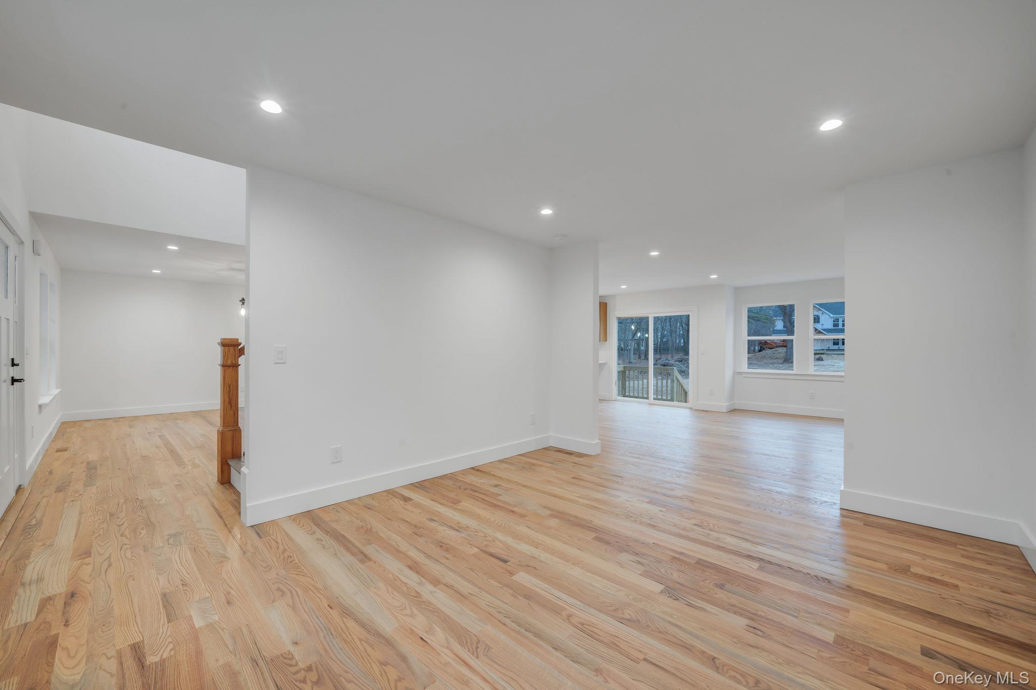 63 C Blydenburgh Road Centereach, NY 11720 - Photo 13 of 38 a view of empty room with wooden floor and kitchen