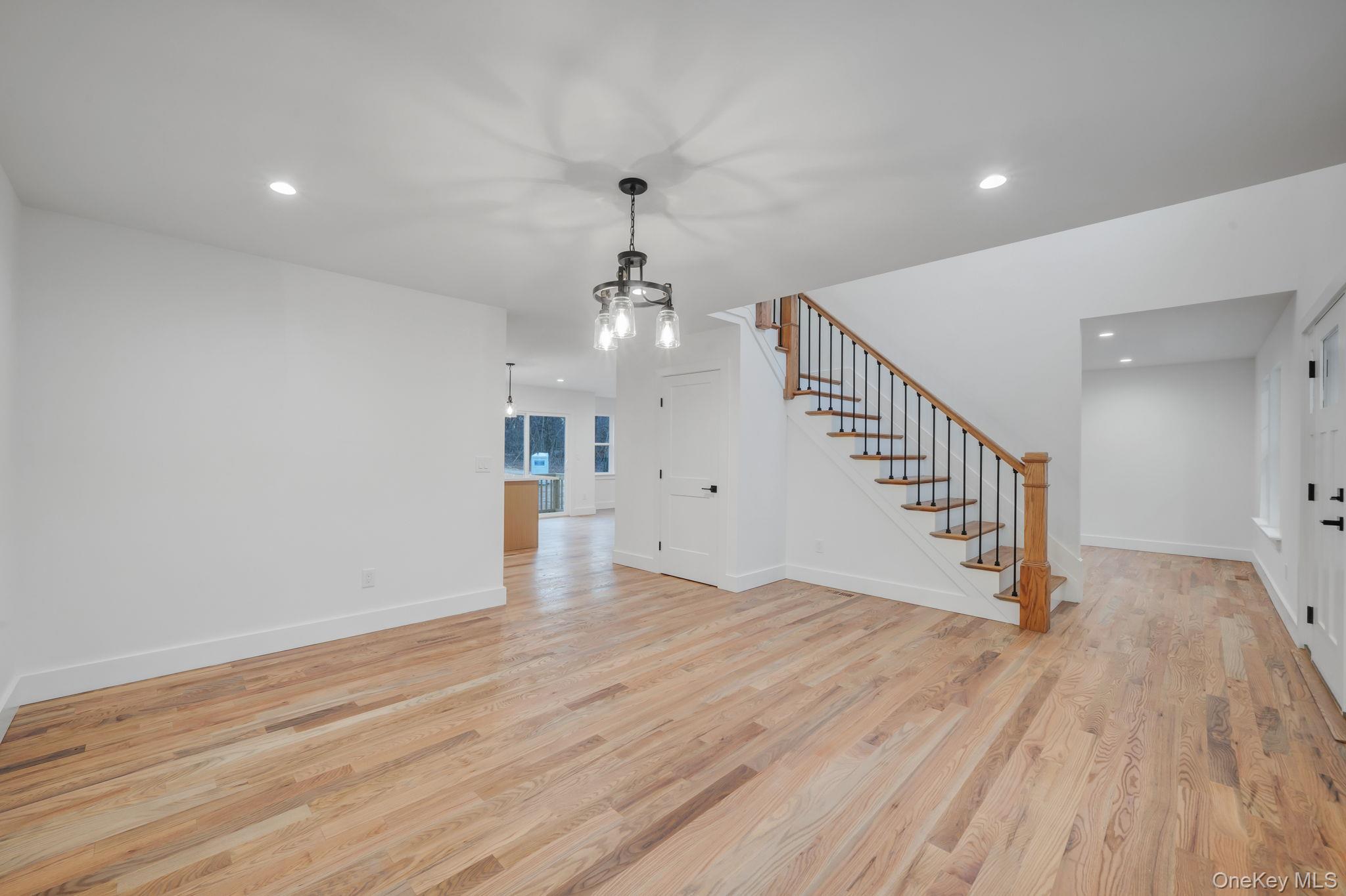 63 C Blydenburgh Road Centereach, NY 11720 - Photo 16 of 38 an entryway in a room with wooden floor and stairs