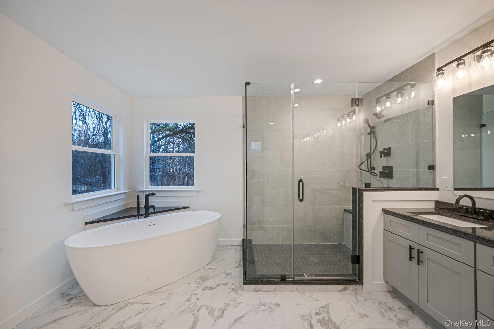63 C Blydenburgh Road Centereach, NY 11720 - Photo 17 of 38 a bathroom with a bathtub shower sink and mirror