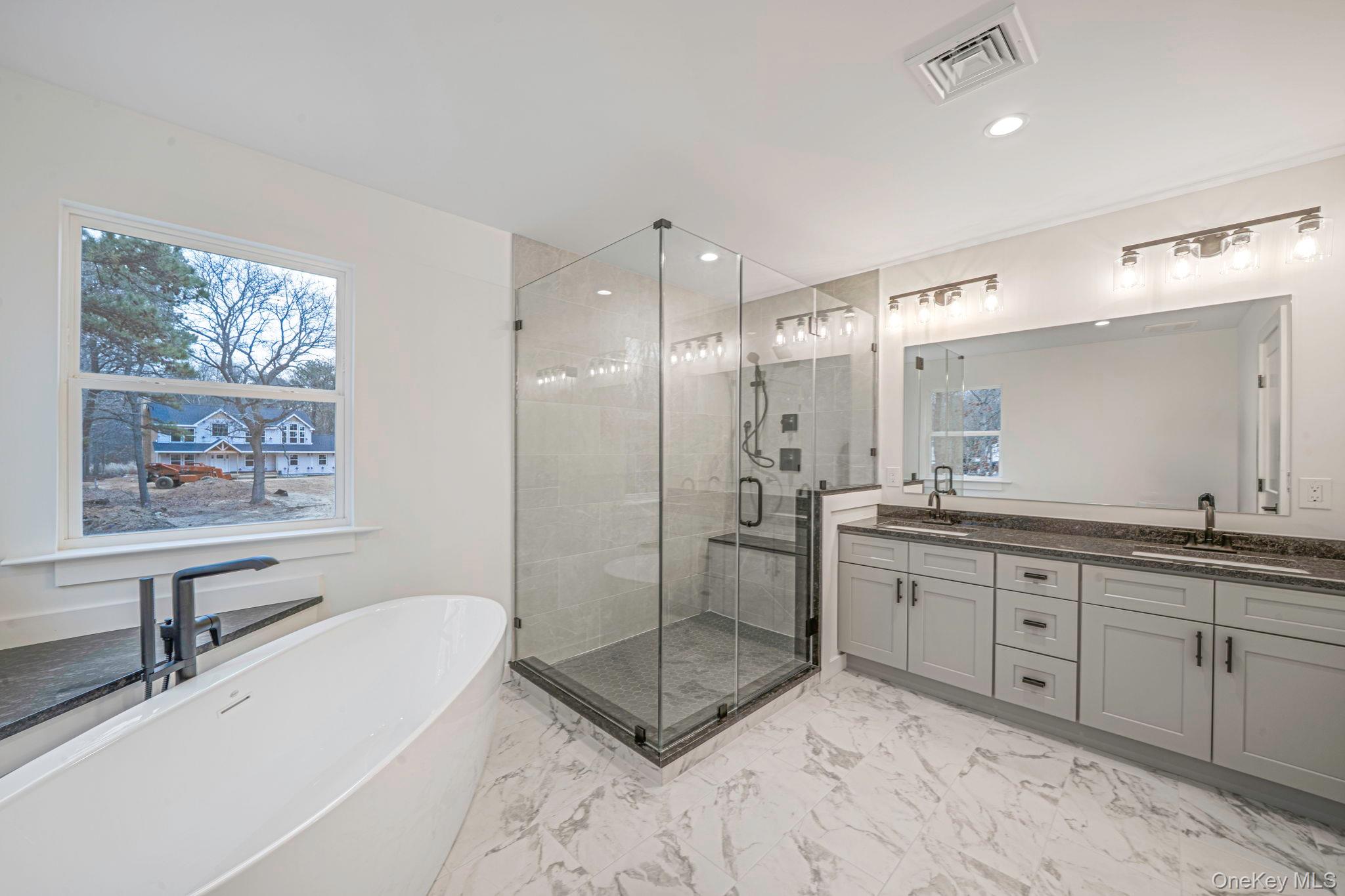 63 C Blydenburgh Road Centereach, NY 11720 - Photo 19 of 38 a spacious bathroom with a tub sink shower and mirror