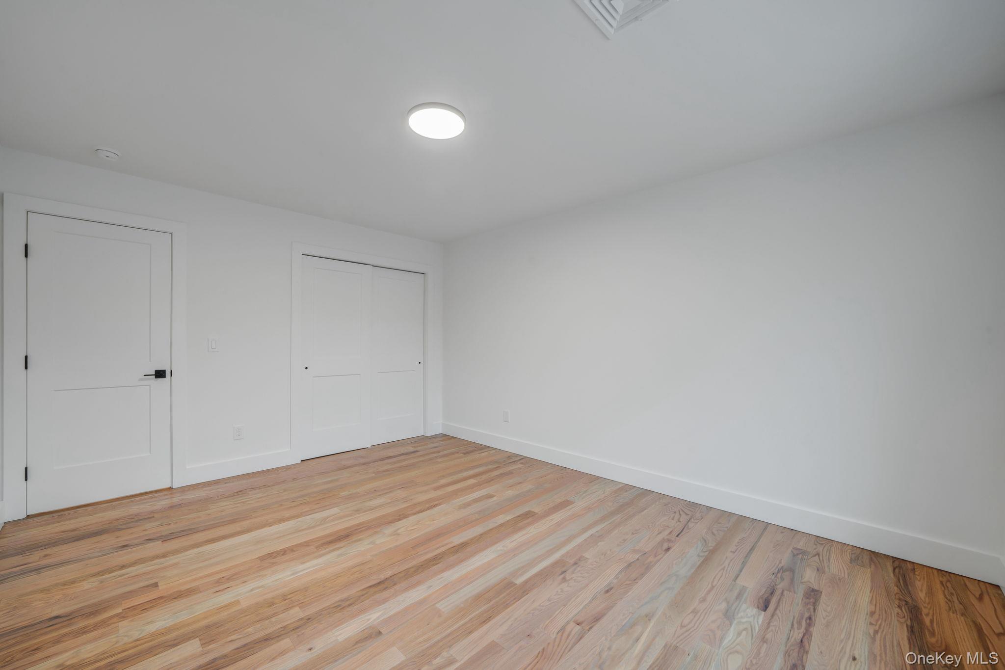 63 C Blydenburgh Road Centereach, NY 11720 - Photo 24 of 38 a view of empty room with wooden floor