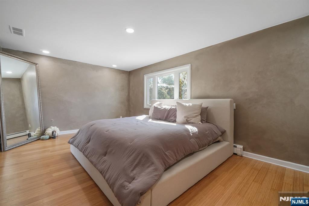 45 Center Street Englewood Cliffs, NJ 07632 - Photo 12 of 18 a bedroom with a bed and a mirror