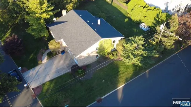 a view of a house with a yard and garden
