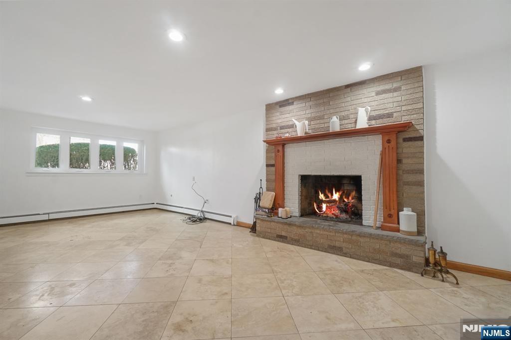 45 Center Street Englewood Cliffs, NJ 07632 - Photo 7 of 18 a view of an empty room with a fireplace and a window