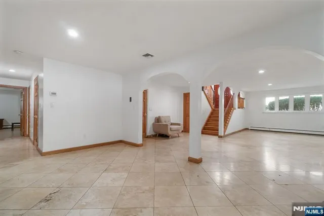 a spacious bathroom with a granite countertop sink mirror and toilet