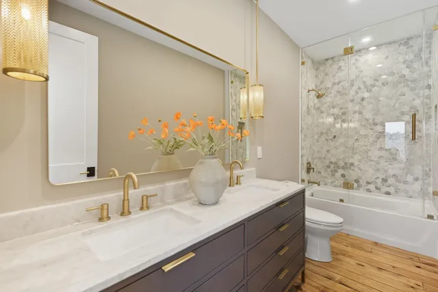 a dining room with furniture large windows and wooden floor