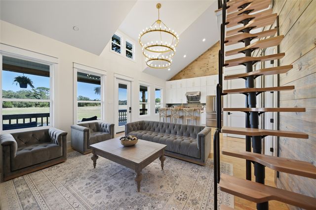 a living room with furniture and a book shelf