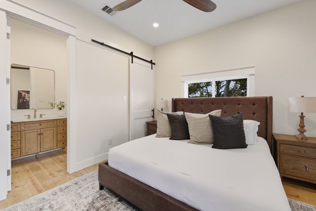 a bedroom with a large bed and a dresser