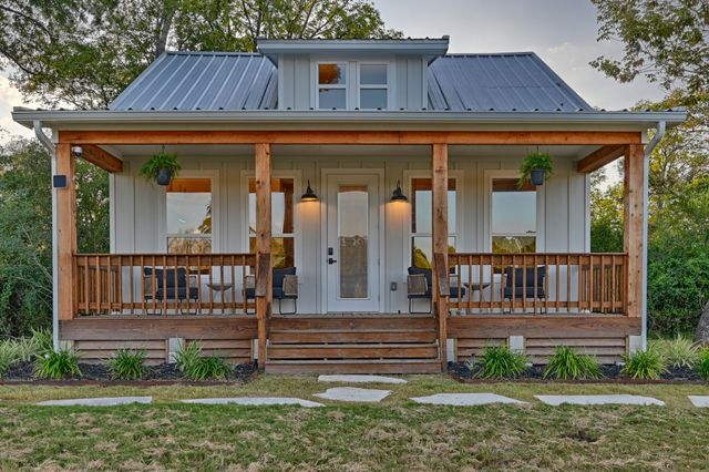 a view of a house with wooden fence