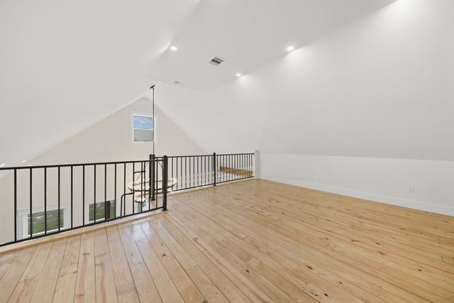a view of hallway with wooden floor
