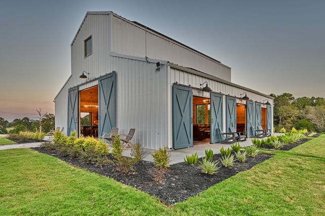 a view of a house with brick walls and a yard with plants