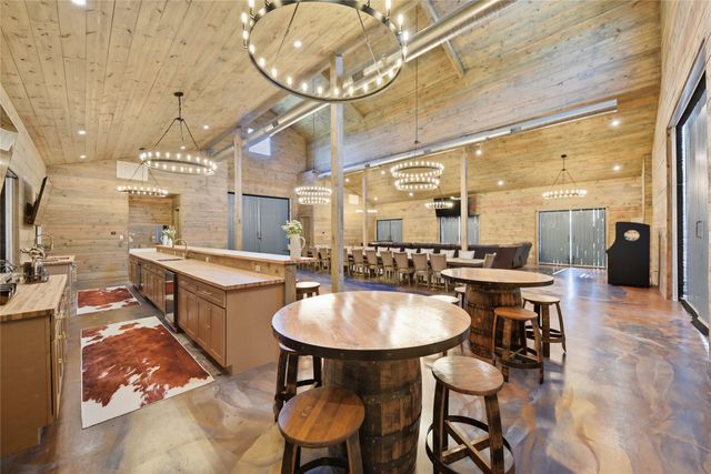 a large kitchen with a table and chairs