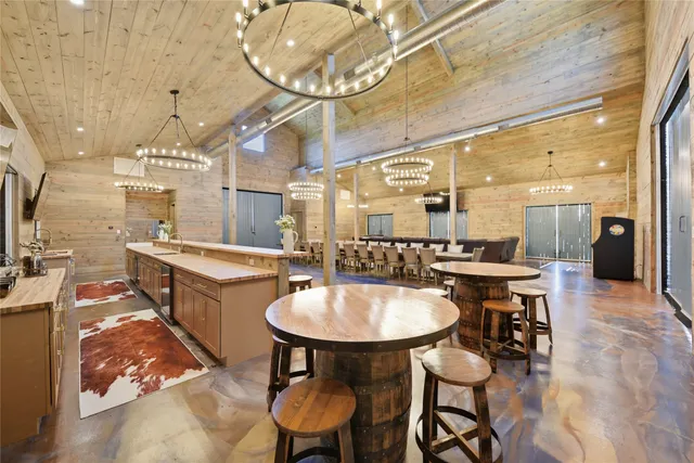 a large kitchen with a table and chairs