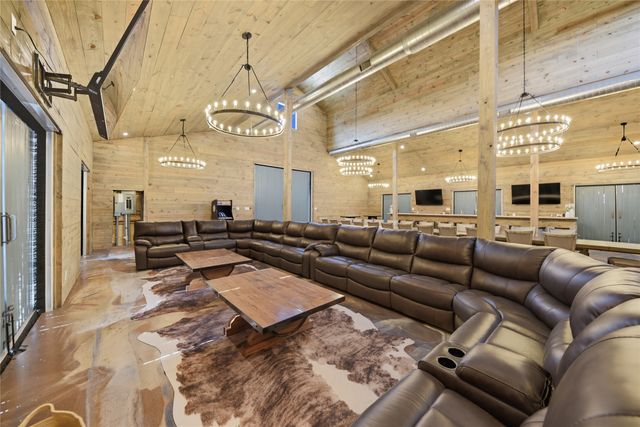 a living room with lots of furniture and a chandelier