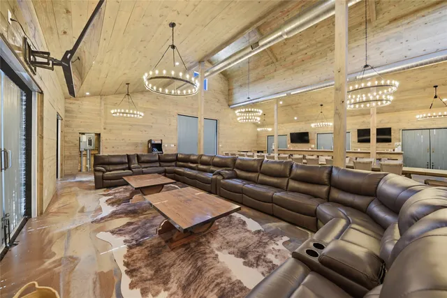 a living room with lots of furniture and a chandelier