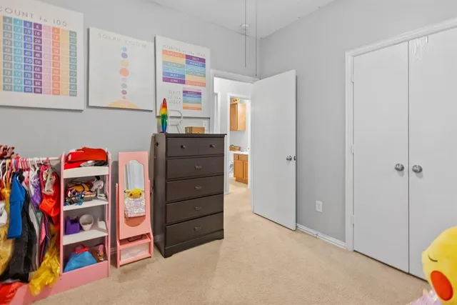 a living room with kitchen island furniture and a chandelier