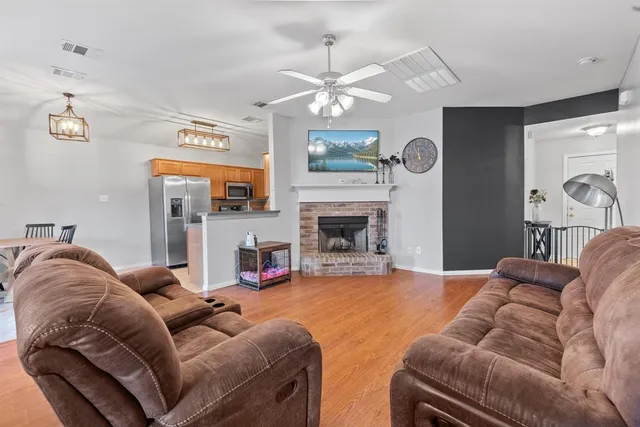 a living room with furniture fireplace and a mirror