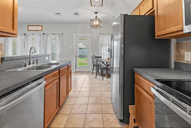 a kitchen with stainless steel appliances granite countertop a stove and a microwave