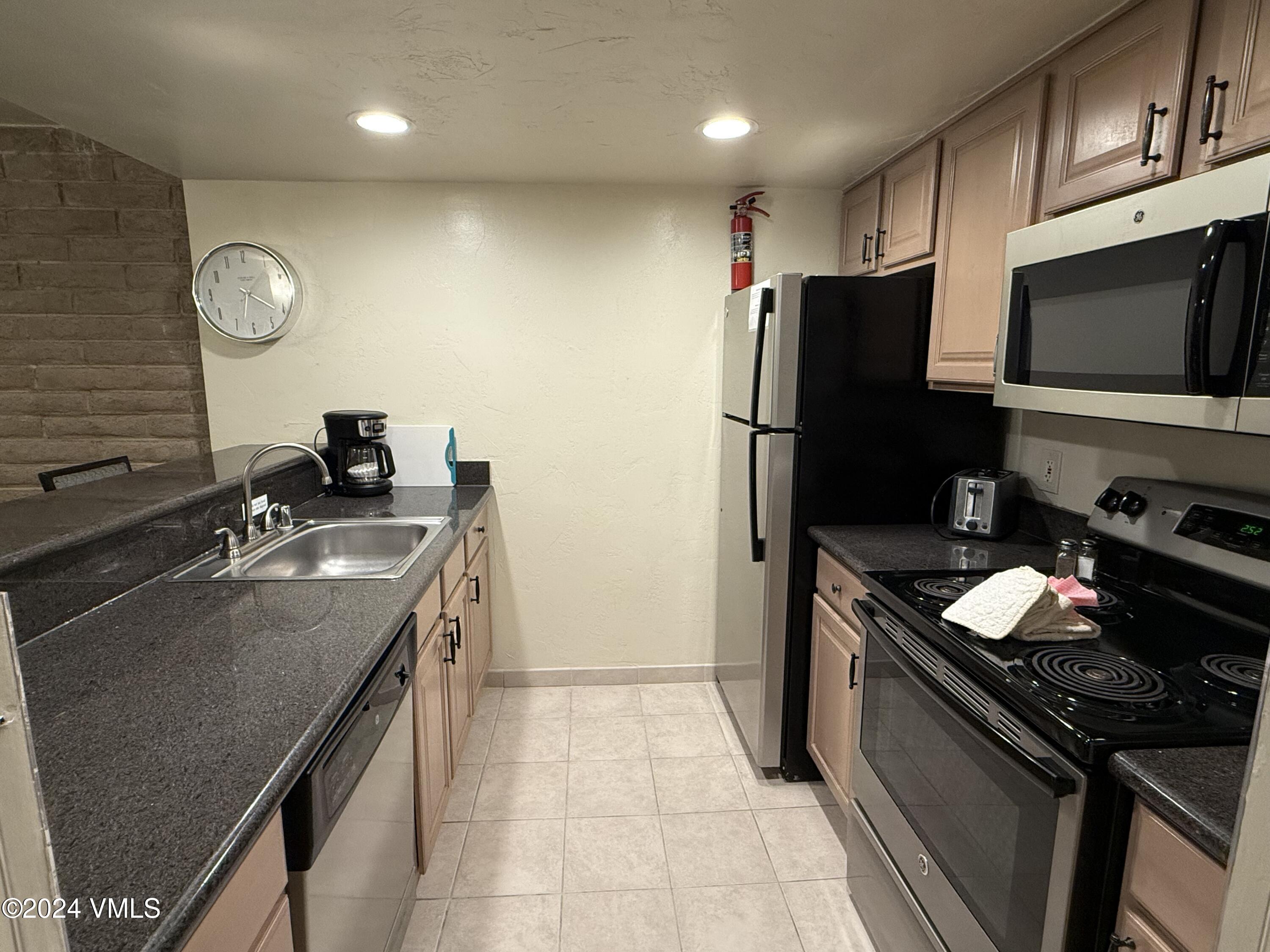 a kitchen with a sink stove and refrigerator