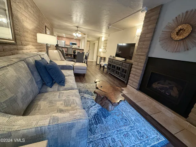 a living room with furniture and a fireplace