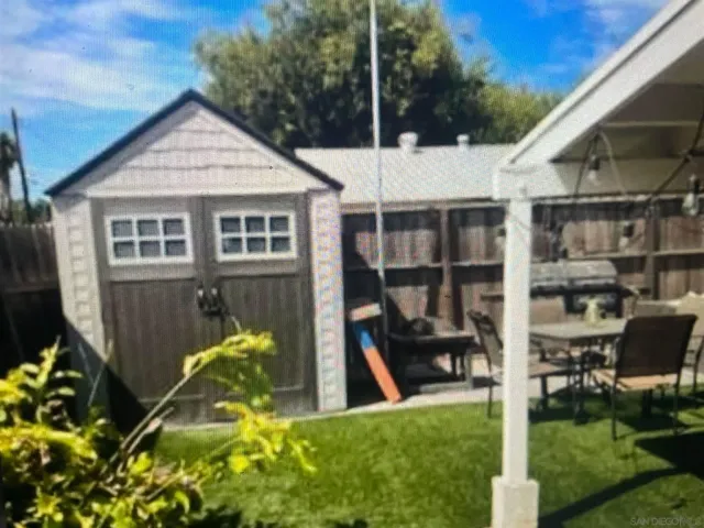 a view of a house with wooden fence